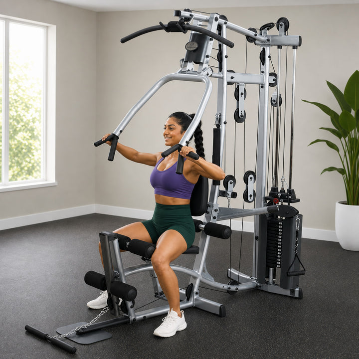 Fit model performing a seated chest press on the Powerline P2X home gym