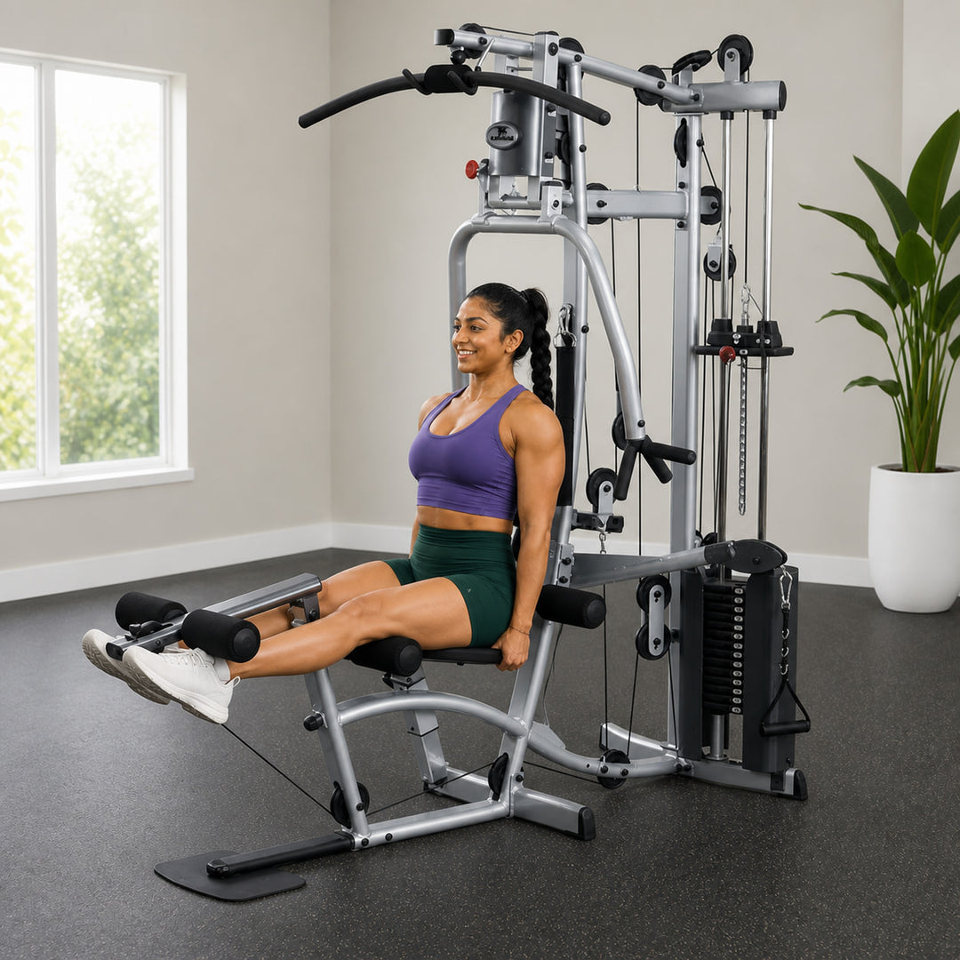 Fit model performing a seated leg extension on the Powerline P2X leg developer