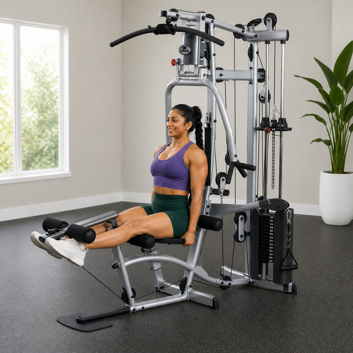Fit model performing a seated leg extension on the Powerline P2X leg developer