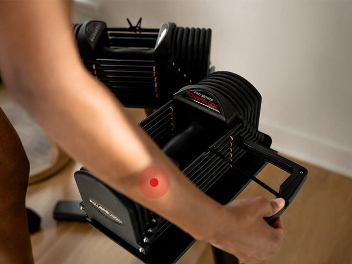 Magnetic selector pin being moved to a new weight setting on the PowerBlock Commercial Pro 32