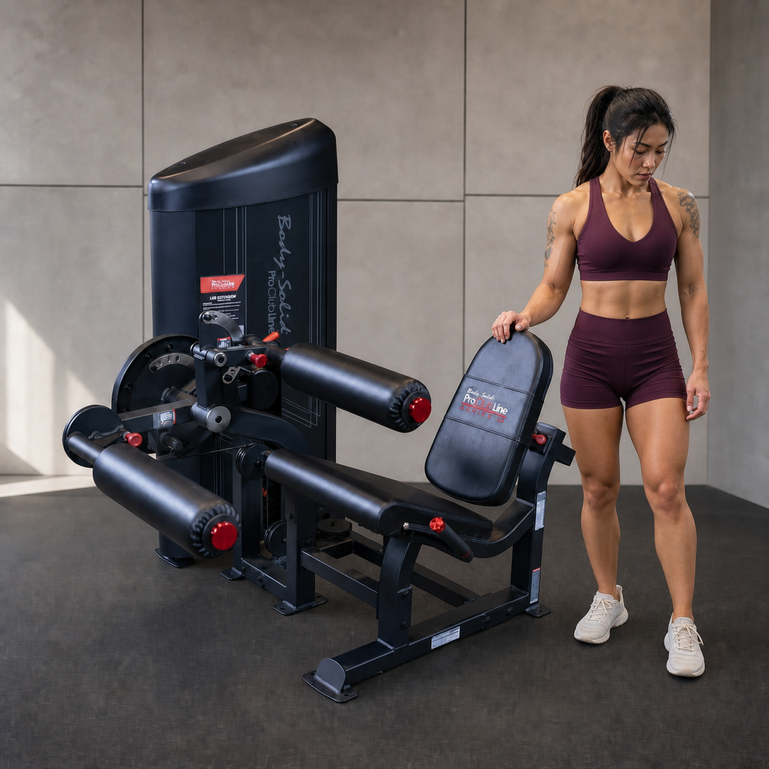 Body-Solid Pro ClubLine S2LECX leg curl and extension machine with athlete beside it for human scale