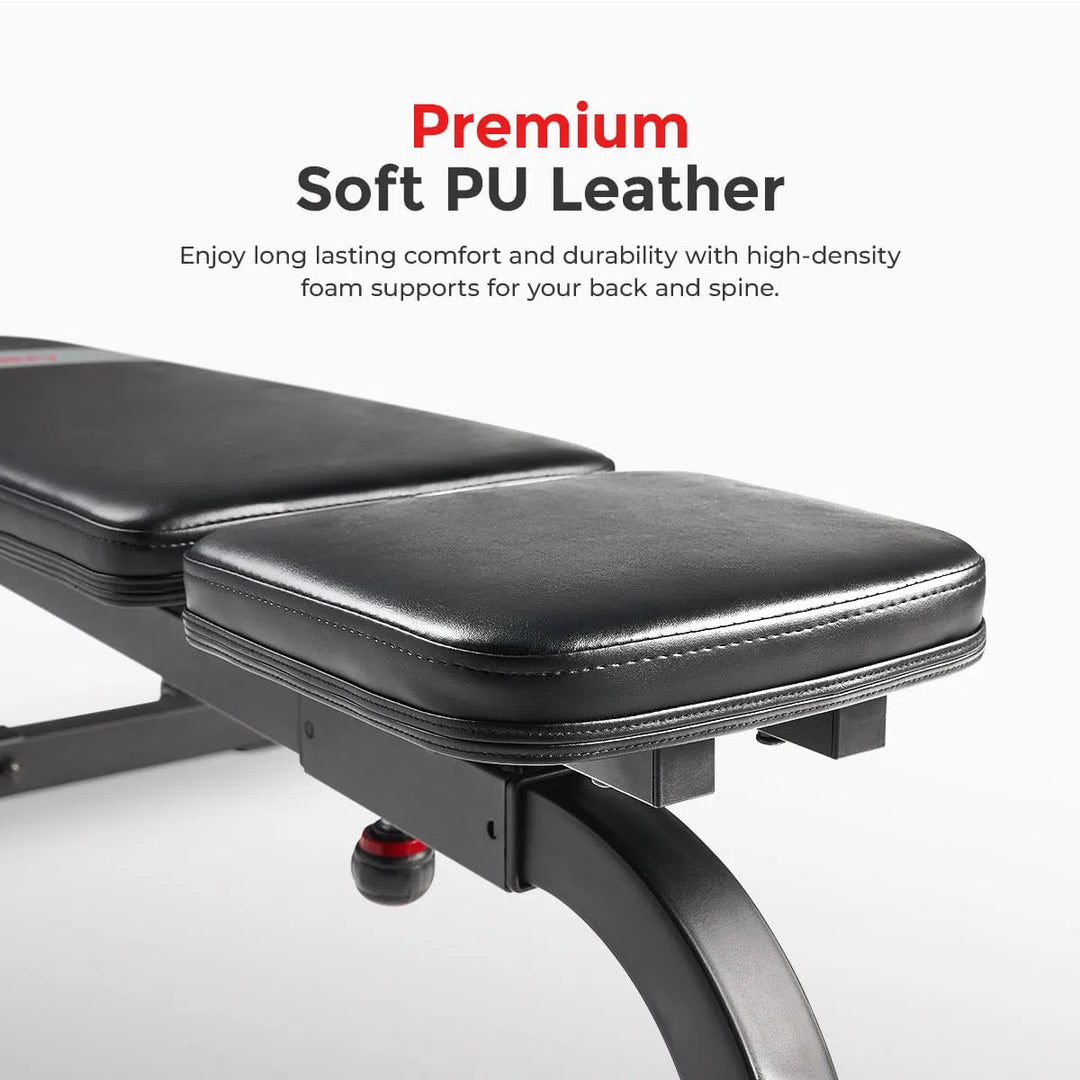 A close-up of the Sunny Health & Fitness Incline Bench shows Premium Soft PU Leather text. The bench offers long-lasting comfort with high-density foam supports for your spine and back on a cushioned surface, all set on a sturdy metal frame.