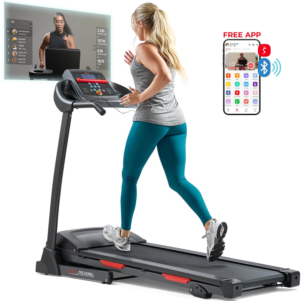 A woman in a gray tank top and teal leggings runs on a Sunny Health & Fitness Premium Folding Treadmill indoors, guided by an onscreen virtual trainer. Her smartphone, marked FREE APP and with a Bluetooth icon, enhances her workout experience.