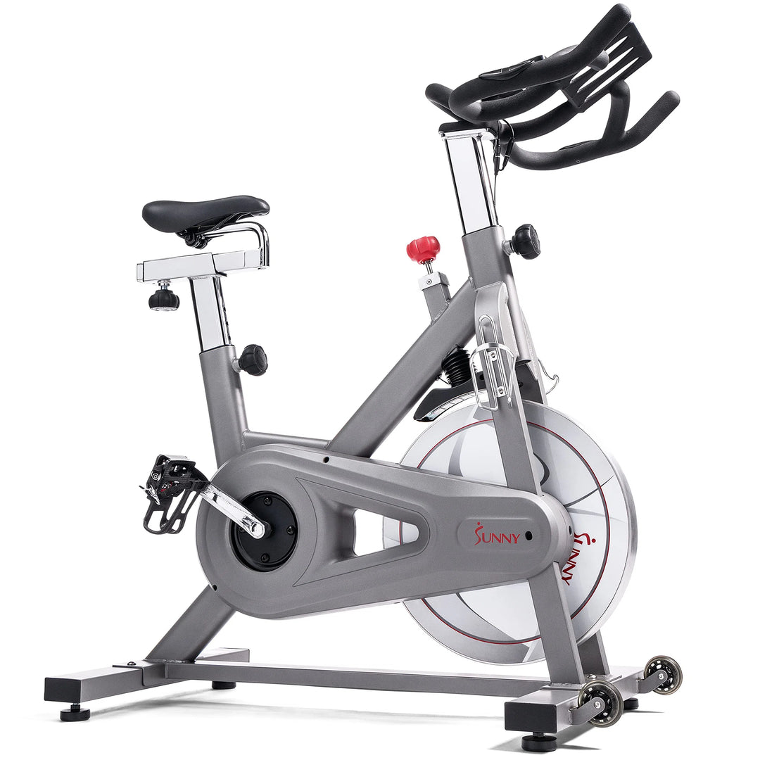 Experience the Sunny Health & Fitness Synergy Series Magnetic Indoor Cycling Exercise Bike in gray, featuring adjustable seat and handlebars. The visible flywheel proudly displays the Sunny brand, and pedal straps enhance stability—making it a perfect invitation to elevate your fitness journey.