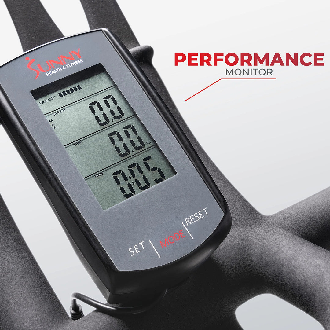 Close-up of the digital monitor on a Sunny Health & Fitness Synergy Series Magnetic Indoor Cycling Exercise Bike shows zeros for target, speed, distance, and time. Buttons below allow mode setting and resetting. PERFORMANCE MONITOR in red ensures easy navigation through CSS-styled layouts.