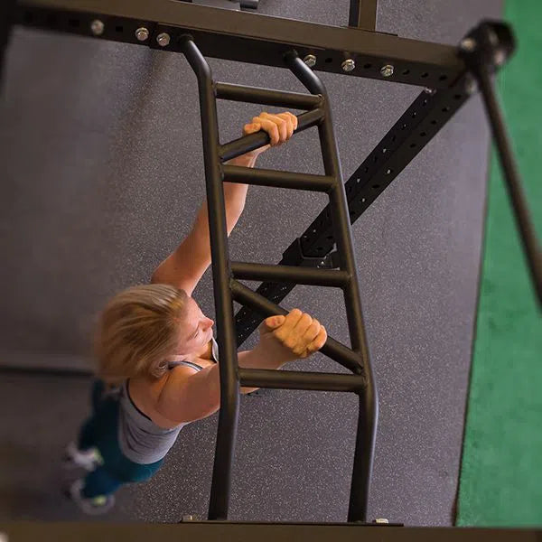 woman hanging from monkey bars on power rack